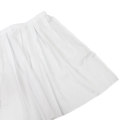 White pleated skirt on a plain background