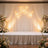 Elegant event stage with draped fabric and floral arrangements.