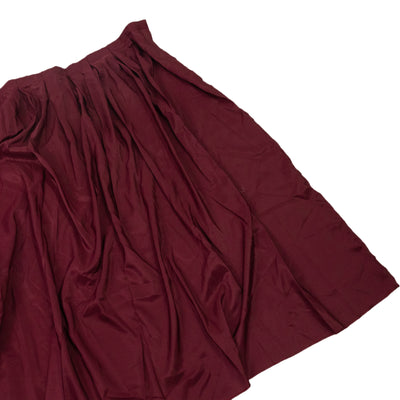 Burgundy pleated skirt on a plain white background