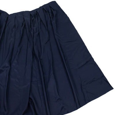 Navy pleated fabric drape on white background