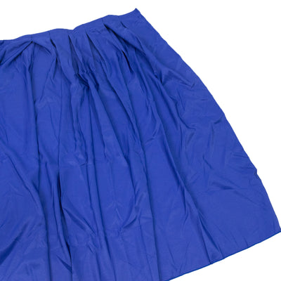 Blue pleated fabric draped on a plain background
