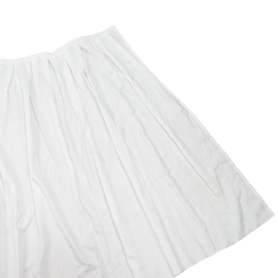 White pleated tablecloth on a plain background