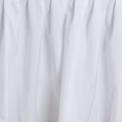 White fabric draped elegantly, showcasing a soft, flowing texture.