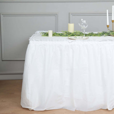 White table skirt with elegant decor for events and gatherings.