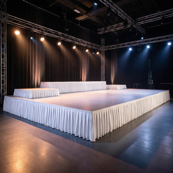 Empty fashion runway stage with lighting truss and white draped platforms