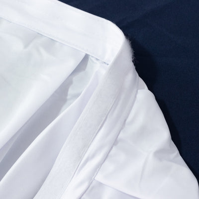 Close-up of white fabric garment seam on dark blue background