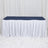 White banquet table with navy table cover and white pleated skirt on display