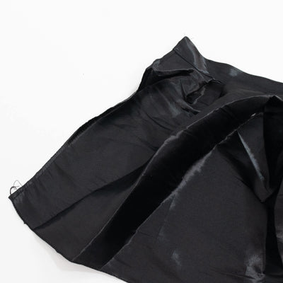 Black satin fabric close-up on white background, folded textile texture#whtbkgd