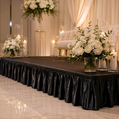 Elegant wedding stage with white floral arrangements and candles