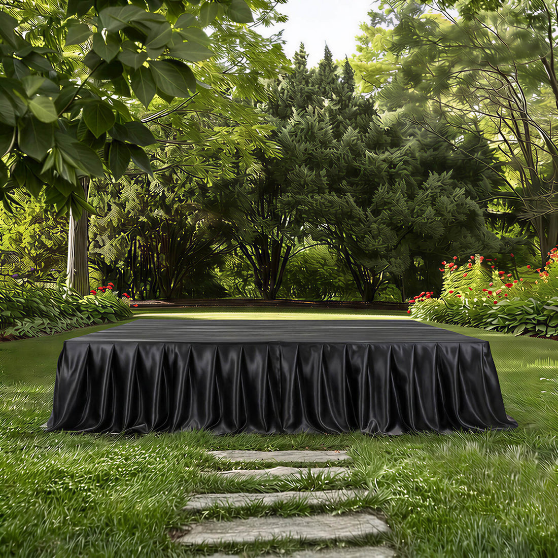 Elegant black draped table in lush green garden setting