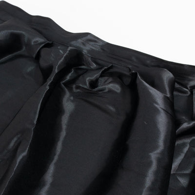 Black satin fabric with soft folds and a glossy sheen