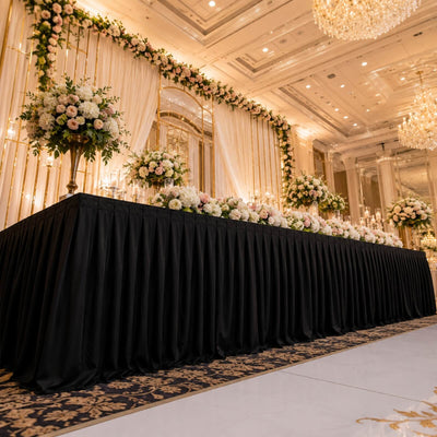 Elegant wedding reception stage with floral backdrop in luxury ballroom