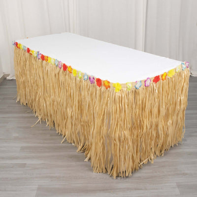 Tropical table skirt with colorful floral accents for festive decor.