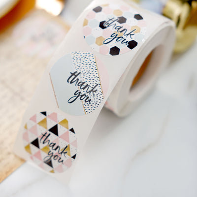 Roll of decorative "thank you" stickers in various designs.