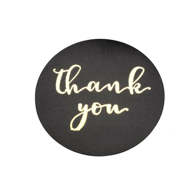 Black round thank you card with elegant gold lettering