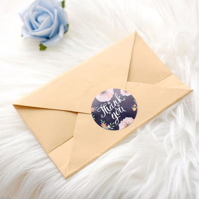 Thank you card envelope with floral sticker on soft white fur texture.