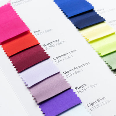 Satin fabric swatches in various colors including red, burgundy, and violet.