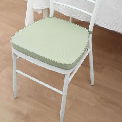 White chair with a light green cushion on a wooden floor.