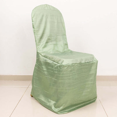 Green chair cover on a plain chair against a white backdrop.