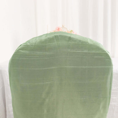 Green chair cover on a plain backdrop.