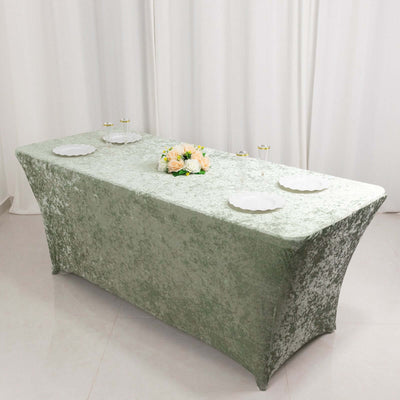 Green velvet tablecloth on a rectangular table with floral centerpiece.