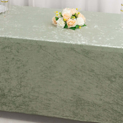 Elegant green tablecloth with floral centerpiece for decor.