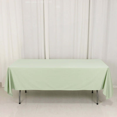 Light green tablecloth draped over a folding table