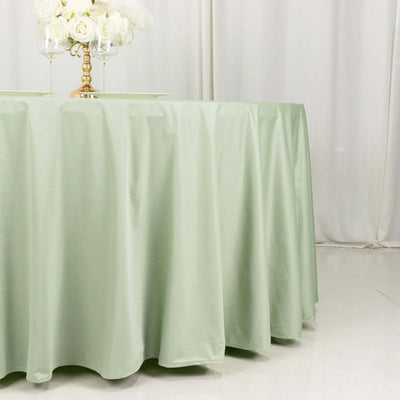Light green tablecloth draped elegantly over a round table.