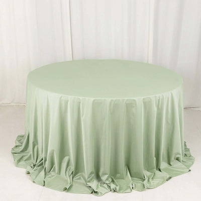 Green round tablecloth with elegant draping fabric.