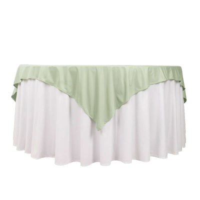 Round tablecloth with green top and white skirt, perfect for events.