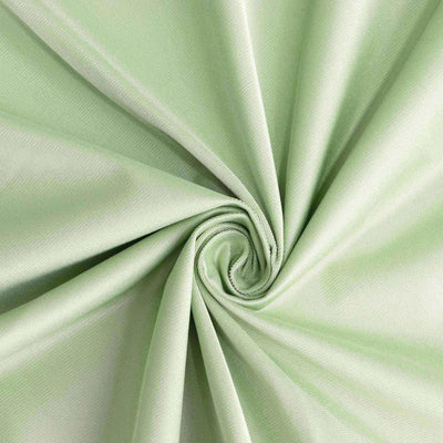 Light green fabric in a spiral arrangement, showcasing smooth texture.