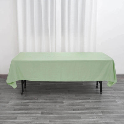 Green tablecloth draped over a black folding table.