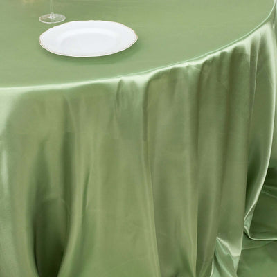 Green satin tablecloth draped elegantly over a table with a white plate.