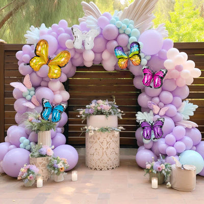 Colorful balloon arch with butterflies for a festive celebration.