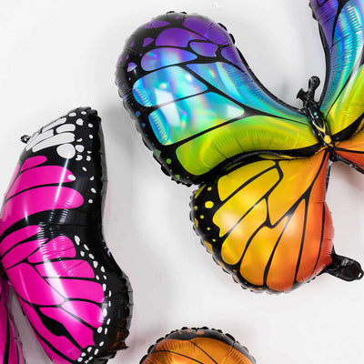 Colorful butterfly-shaped balloons in vibrant pink, orange, and blue hues