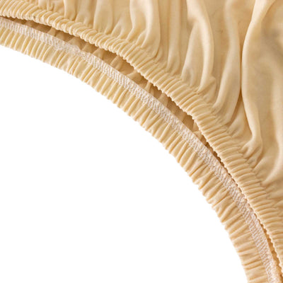 Beige fabric close-up showing soft texture and stretch detail.
