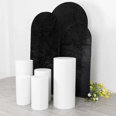 White and black display pedestals on a clean backdrop