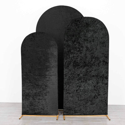 Three arched black velvet backdrops on wooden stands
