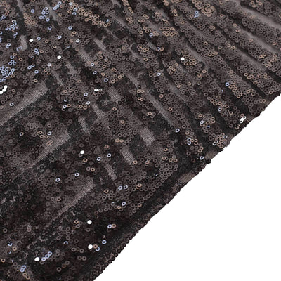 Black sequin fabric with a shimmering texture and dynamic draping.