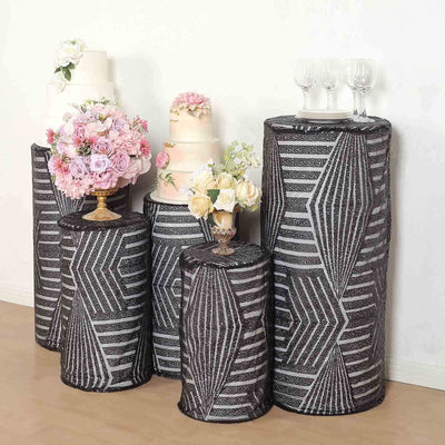 Decorative table covers in black and white geometric patterns for events.