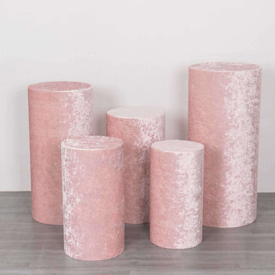 Set of five pink cylindrical pedestals in varying heights