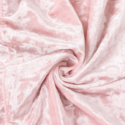 Soft pink velvet fabric with a luxurious texture.