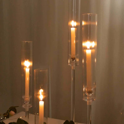 Elegant glass candle holders with lit candles, creating a warm ambiance.