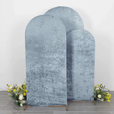 Three arched velvet backdrops in grey with floral accents.