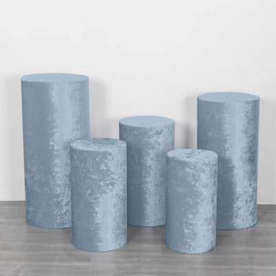 Set of five blue velvet display pedestals in varying heights