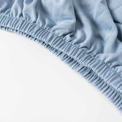 Blue elastic waistband fabric close-up, showcasing soft texture and stretch.
