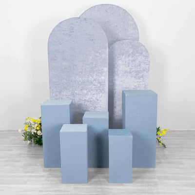 Blue display pedestals with textured backdrops in a studio setting.