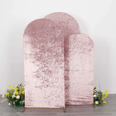 Three pink velvet backdrop panels in varying heights against a plain background.