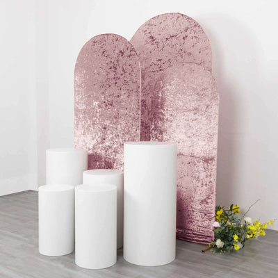 White pedestals with pink backdrop in studio setting