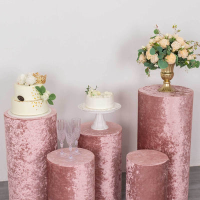 Elegant pink velvet cake stands with floral arrangements and champagne glasses.